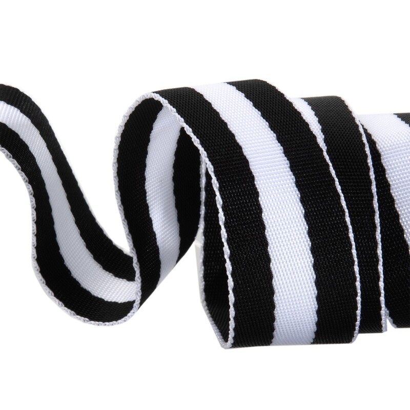 Black and white striped ribbon, curled and resting on a flat surface.
