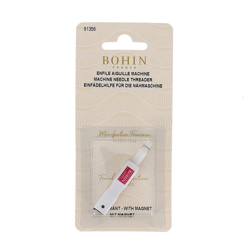 Machine needle threader from Bohin on a beige background.