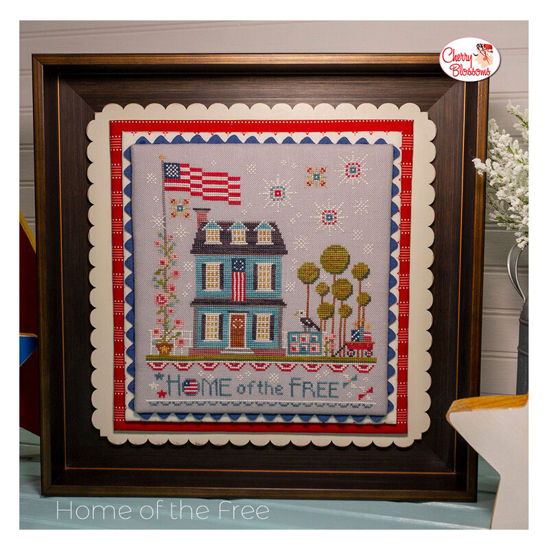 The completed Home of the Free cross stitch pattern framed and surrounded by coordinating décor. 