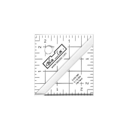 The 2.5" Half-Square Triangle Ruler in its packaging and isolated on a white background. 