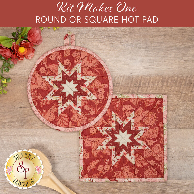 The two completed red Folded Star Hot Pads, one round and one square, slightly overlapping each other and staged on a wooden table with coordinating floral décor.