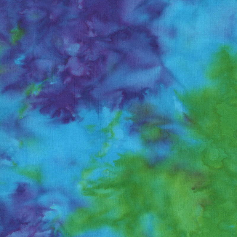 Watercolor batik fabric with violet, peacock blue, and green mottling.