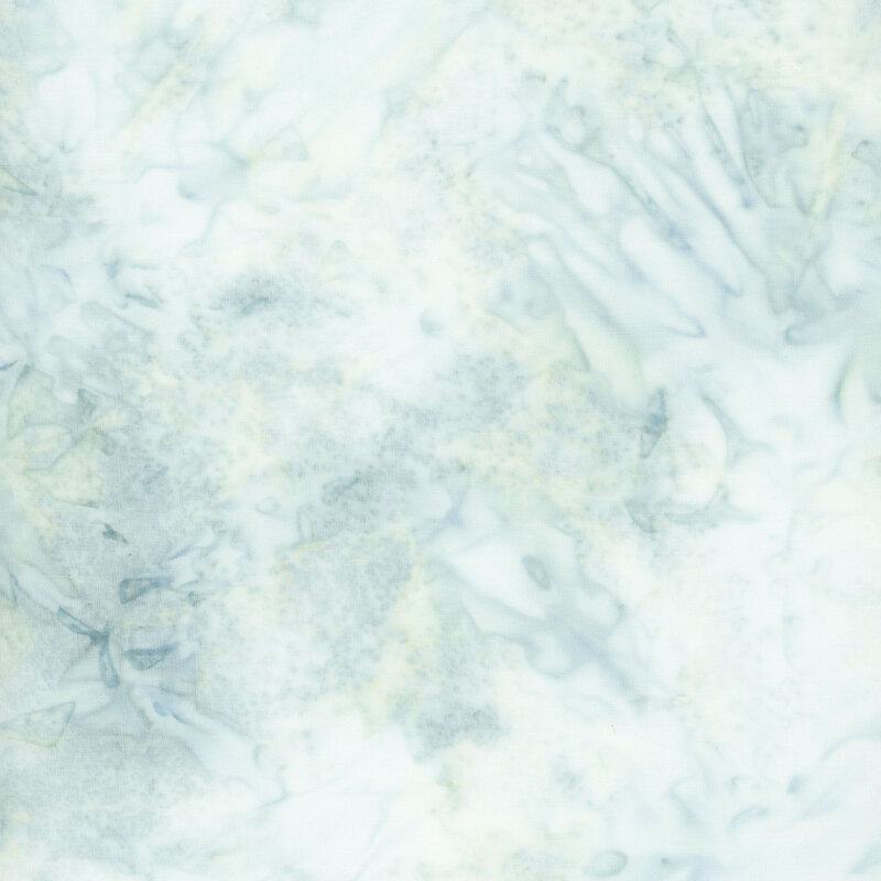 Ice blue watercolor batik fabric with mottling in soft shades of cadet blue and seafoam green.