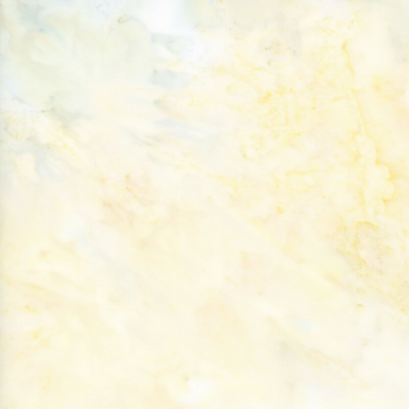 Cream watercolor batik fabric with blue toned mottling.