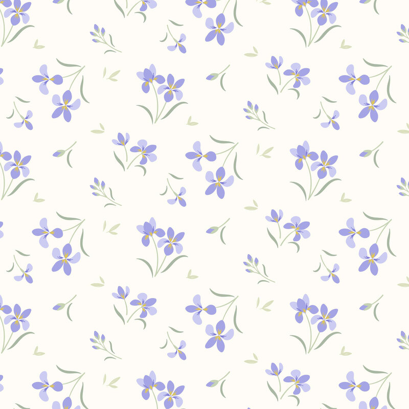 tossed iris blooms with green leaves on a soft cream background.