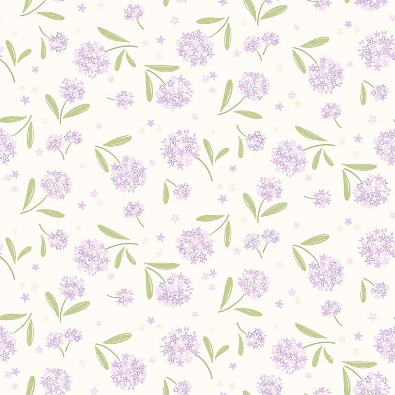 clusters of lavender floral blossoms with green leaves tossed on a soft cream background with scattered petals.