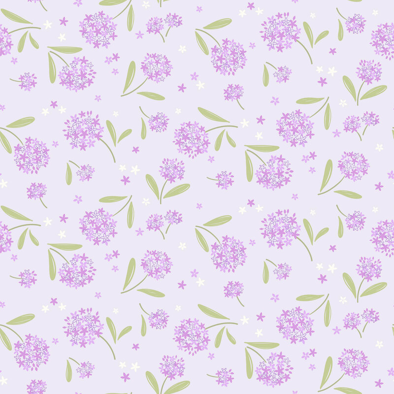 clusters of lilac and white floral blossoms with green leaves tossed on a pale lavender background with scattered petals.