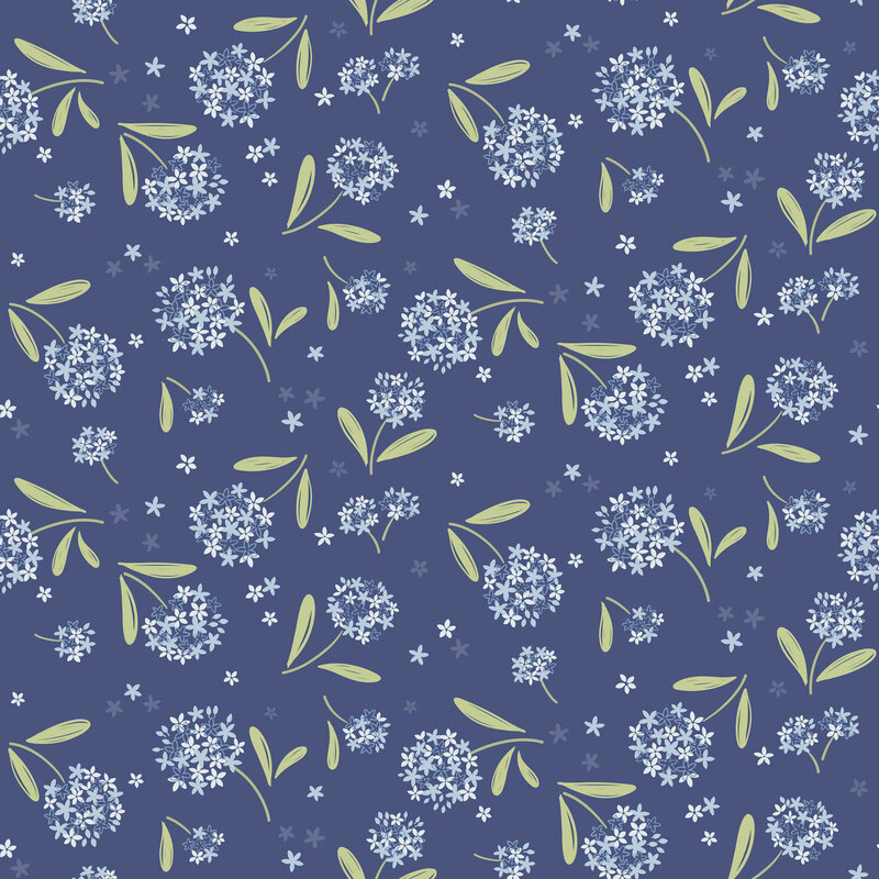 clusters of blue and white floral blossoms with green leaves tossed on a dark blue background with scattered petals.