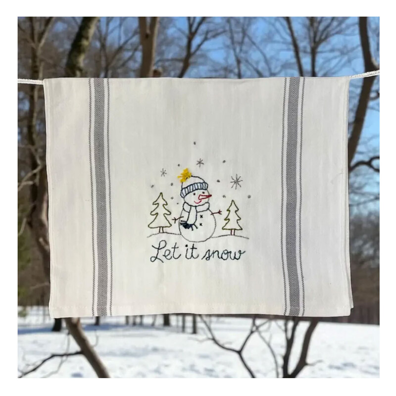 A decorative kitchen towel featuring a snowman.
