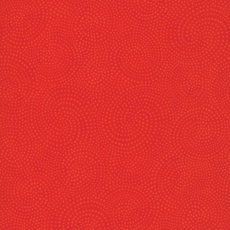 bright red fabric with tonal red swirling decorative patterns throughout the surface.