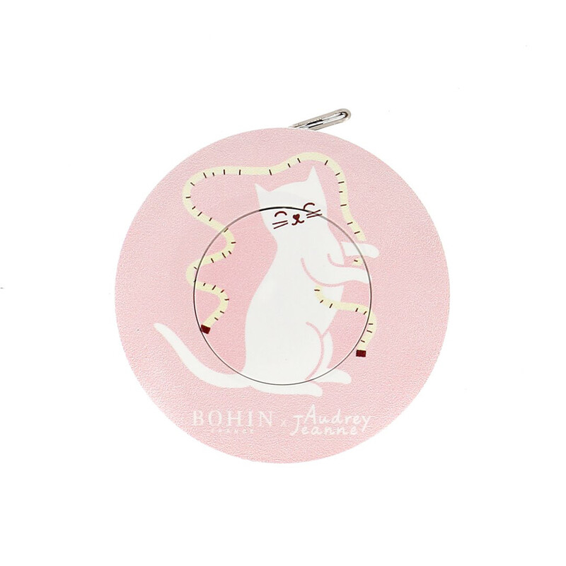An isolated shot of the pink cat tape measure by Bohin on a white background. 