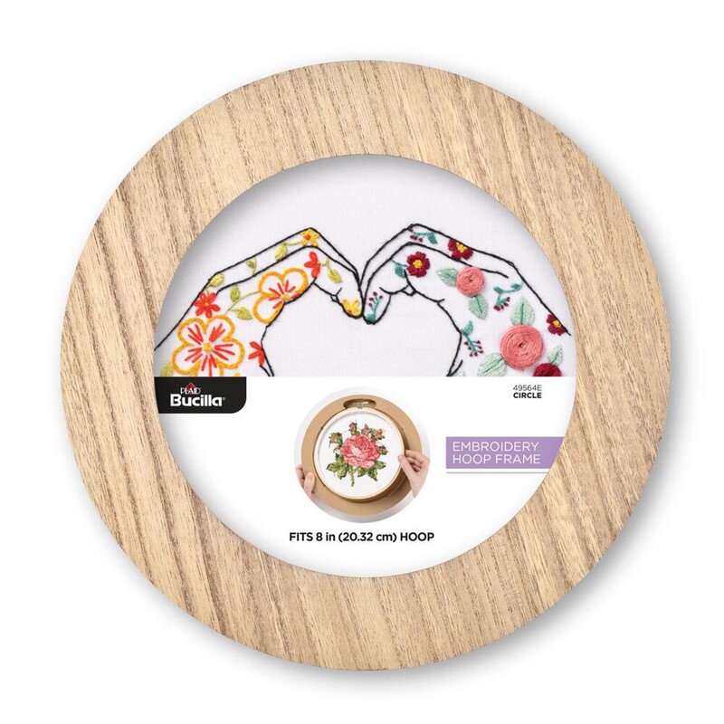 Round embroidery hoop frame with wood veneer finish.