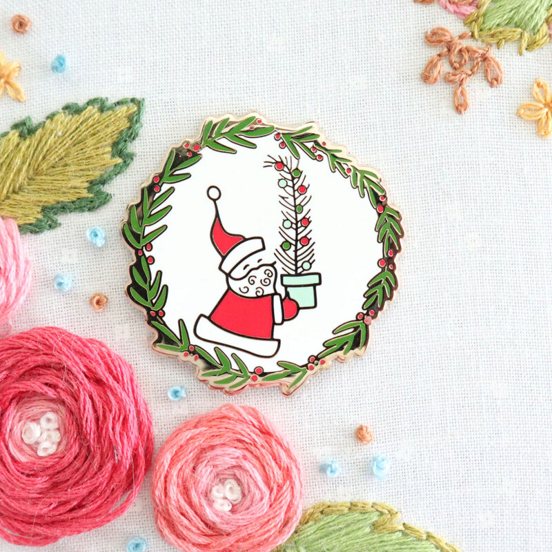 The Vintage Santa needle miner displayed on a hand embroidery project.