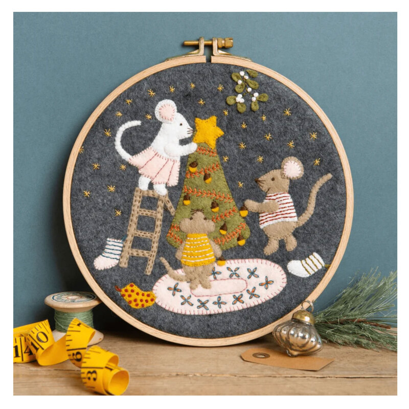 The completed Christmas with the Mouse Wool Mix Appliqué Kit in its hoop and surrounded by coordinating décor. 