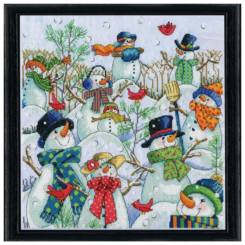 framed cross stitch project featuring multiple snowmen dressed in hats and scarves with red birds fluttering around.