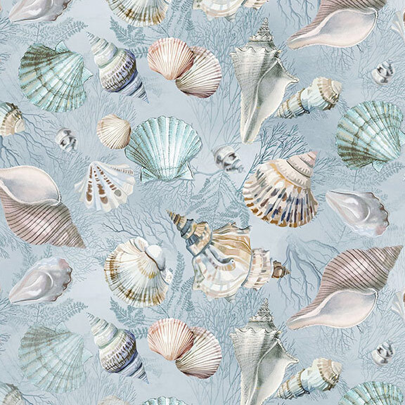 Mottled pale blue fabric with tonal leaves and branches topped with an assortment of multicolor seashells.