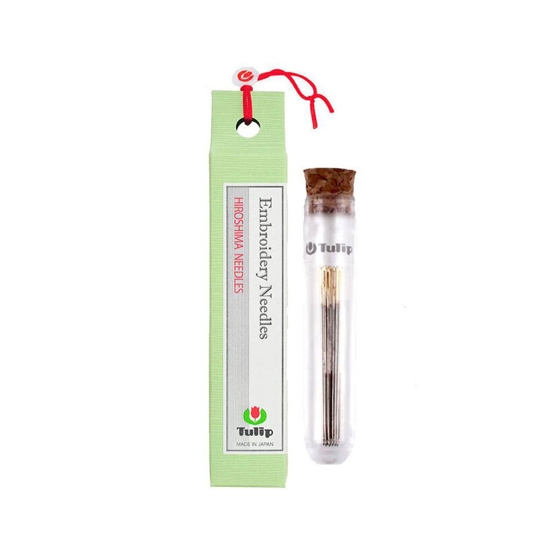 8 piece set of #7 Tulip embroidery needles in a thin container next to a green carton package.