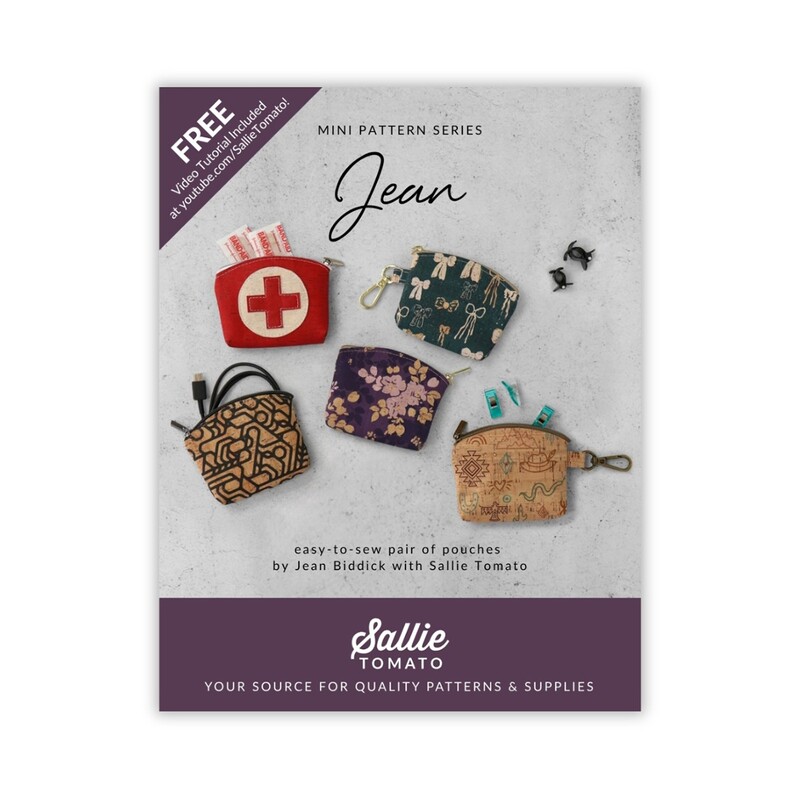 Front cover of pattern showing five versions of the completed Jean bag, staged on a white marble countertop.