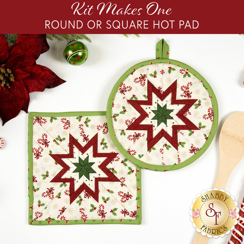 The two completed Folded Star Hot Pads colored in red, green, and white fabrics from the Peppermint & Pine collection by Marcus Fabrics, one round and one square, slightly overlapping each other and staged on a white table with coordinating décor.
