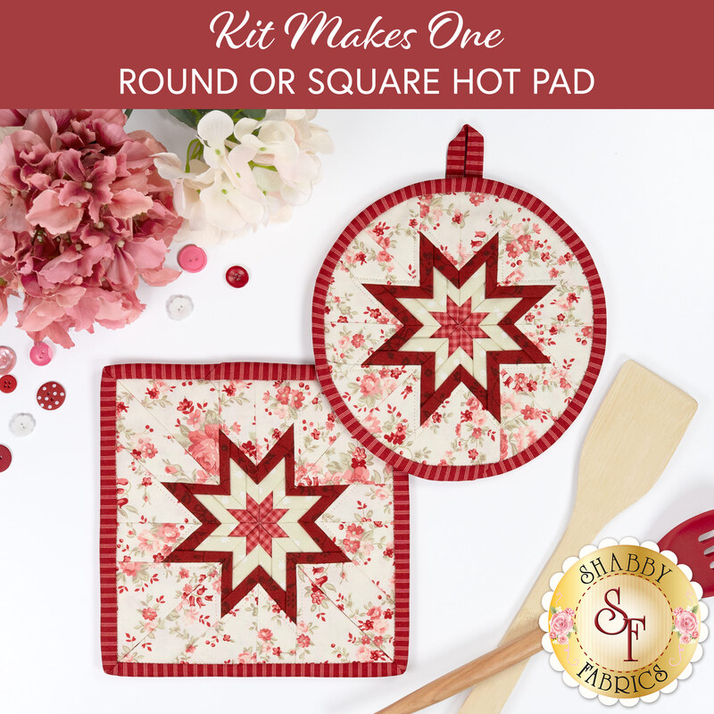 The two completed cream Folded Star Hot Pads, one round and one square, slightly overlapping each other and staged on a white table with coordinating florals, buttons, and kitchen utensils.
