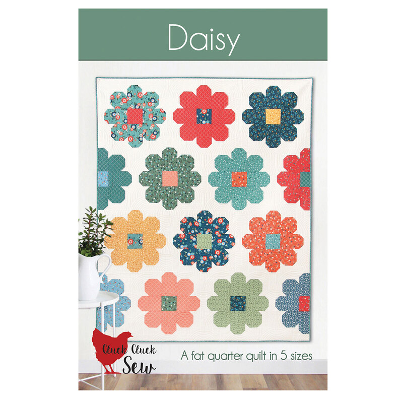 The front of the Daisy quilt pattern featuring a patchwork floral quilt by Cluck Cluck Sew.