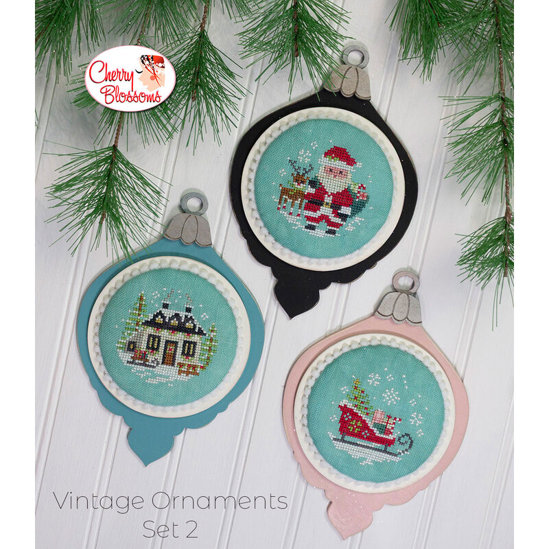 The completed projects, staged on a wooden background and surrounded by coordinating festive greenery.