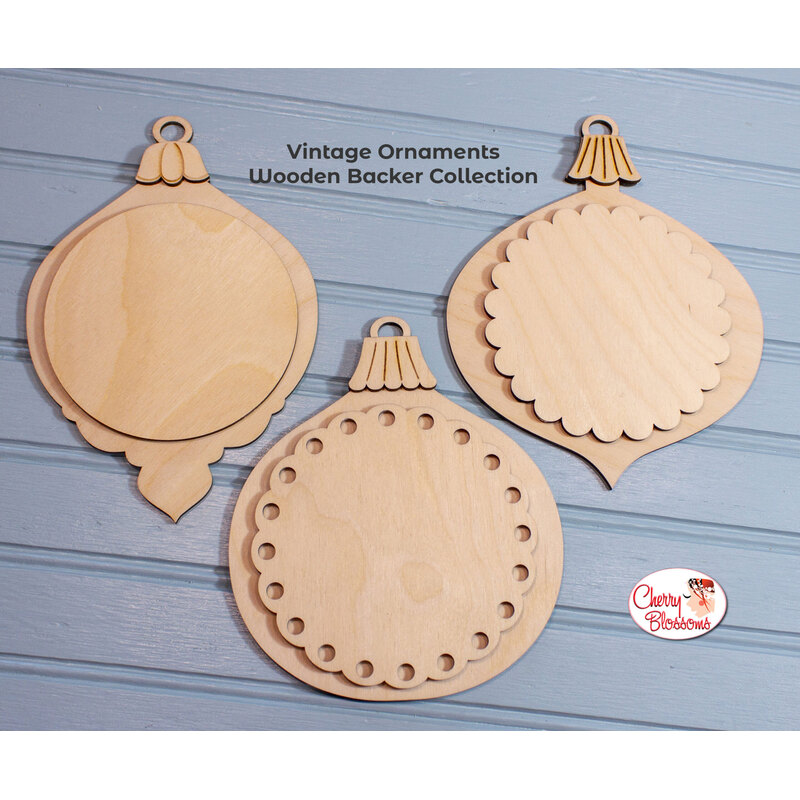 Three blank wooden ornament backers, staged on a dark gray background.