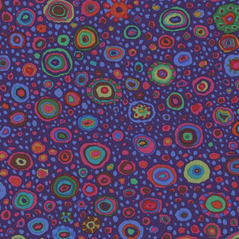 Rich purple fabric featuring multicolor dots in various sizes and color combinations.