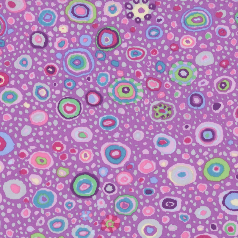 Mauve fabric featuring multicolor dots in various sizes and color combinations.