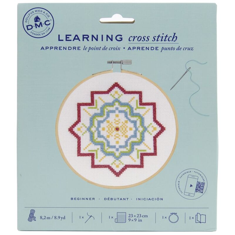The front of the DMC Learning Cross Stitch kit in its packaging. 