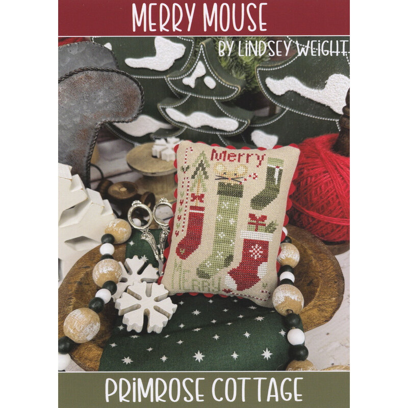 Holiday cross-stitch pattern cover with a stitched “Merry” stocking and Christmas decorations.