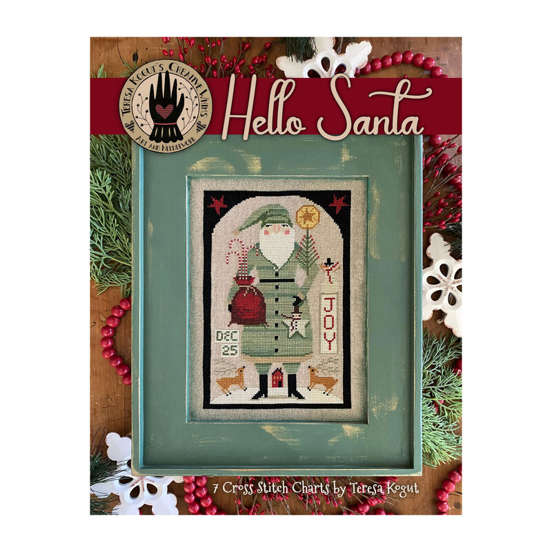 Front cover with the finished Green Coat Santa cross stitch pattern with Santa holding his present bag, a snowman ornament, and a small Christmas tree in front of a red house.