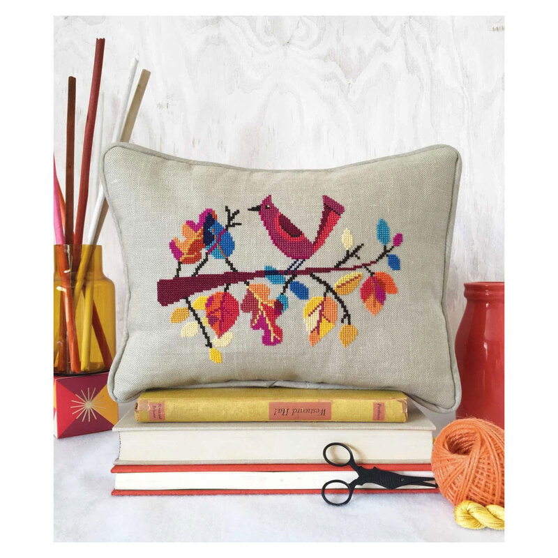 The Autumn Bird cross stitch pattern finished as a pillow and staged with decor