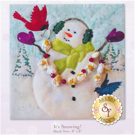 A happy snowman with cardinal and popcorn garland celebrating a snowfall.