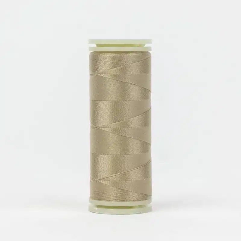 A spool of WonderFil DecoBob DB-115 Taupe thread on a white background.