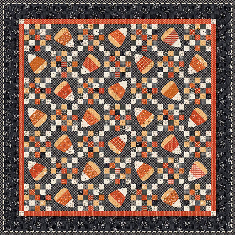 Patchwork quilt with repeating autumn-colored triangular motifs and a dark border.