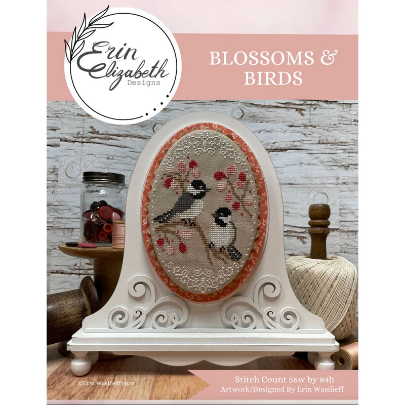 A finished and framed blossoms and birds pattern with coordinating décor and a stitch count in the bottom right corner. 