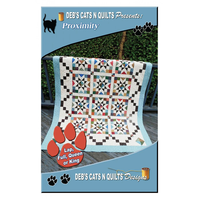 The front of the Proximity pattern with the completed quilt displayed hanging over a fence.