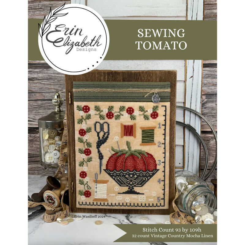 A finished and framed Sewing Tomato pattern with coordinating décor and a stitch count in the bottom right corner. 
