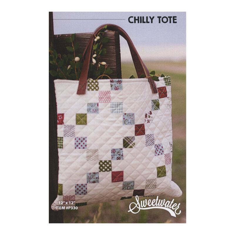 The front of the Chilly Tote pattern, showcasing the finished tote hung on a fence in a field.