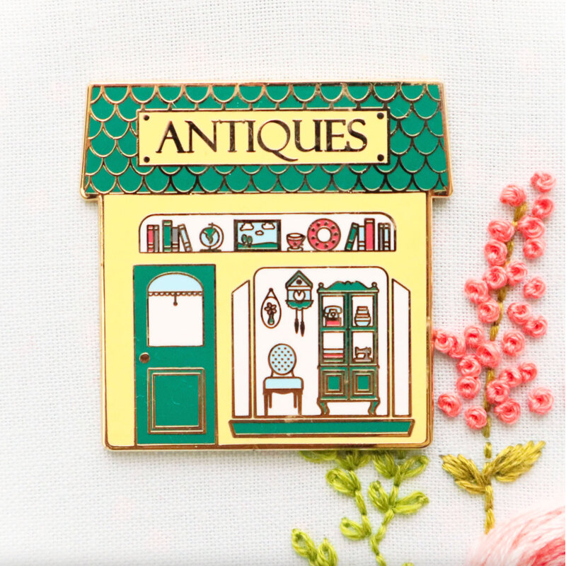 The Antique Shop needle minder displayed on a hand embroidery project.