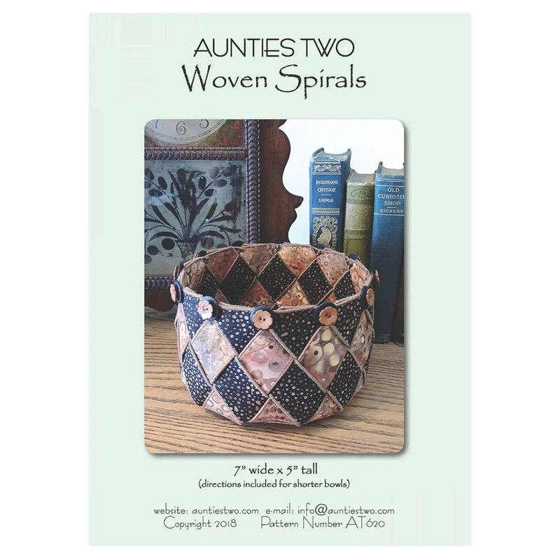 Front Cover of the Woven Spirals pattern by Aunties Two featuring a finished woven bowl staged next to a clock and a stack of books.