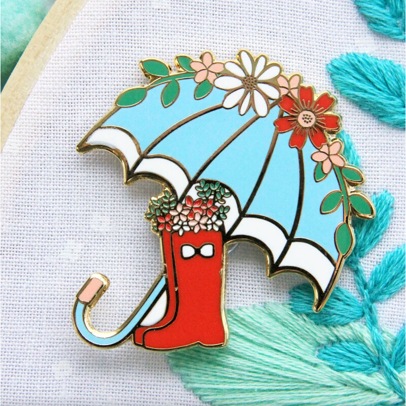The Floral Umbrella and Boots needle miner displayed on a hand embroidery project.