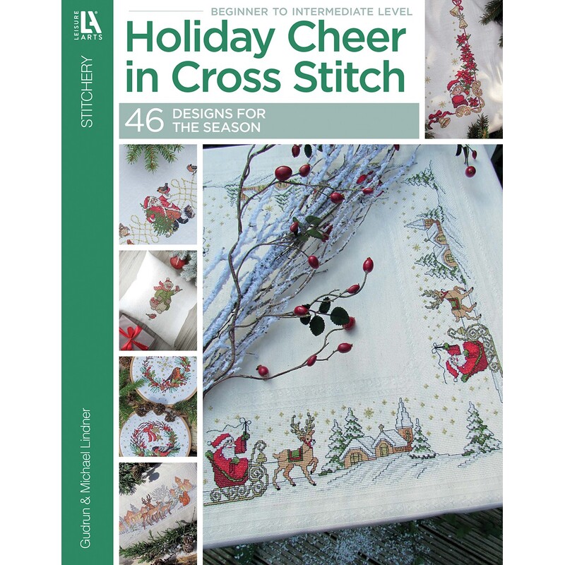 The front of a holiday cross stitch book cover titled “Holiday Cheer in Cross Stitch” with cross-stitch pillow and ornament designs.