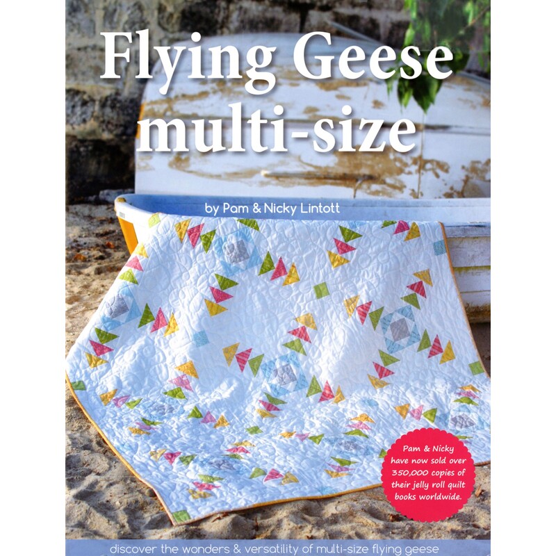 Front cover of the pattern book, showcasing one of the quilts included in the book draped across a boat on the sand.