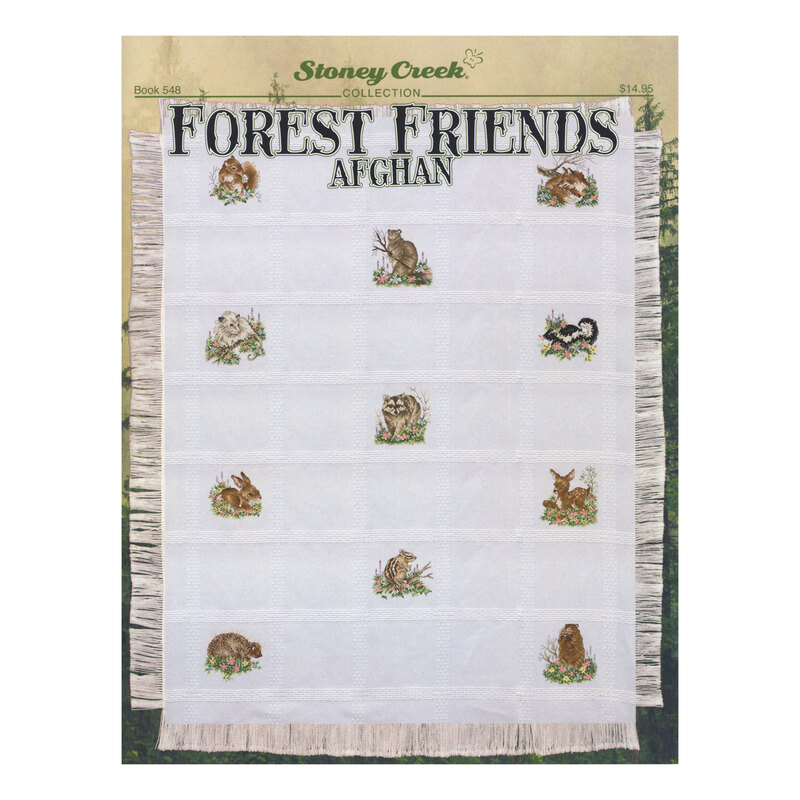 Front cover of the Forest Friends Afghan cross stitch pattern fully stretched out and finished on a white afghan throw.