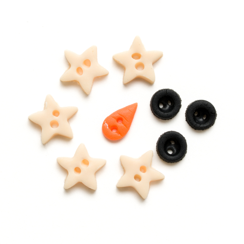 Clay button pack with winter themed charms, isolated on a white background. 
