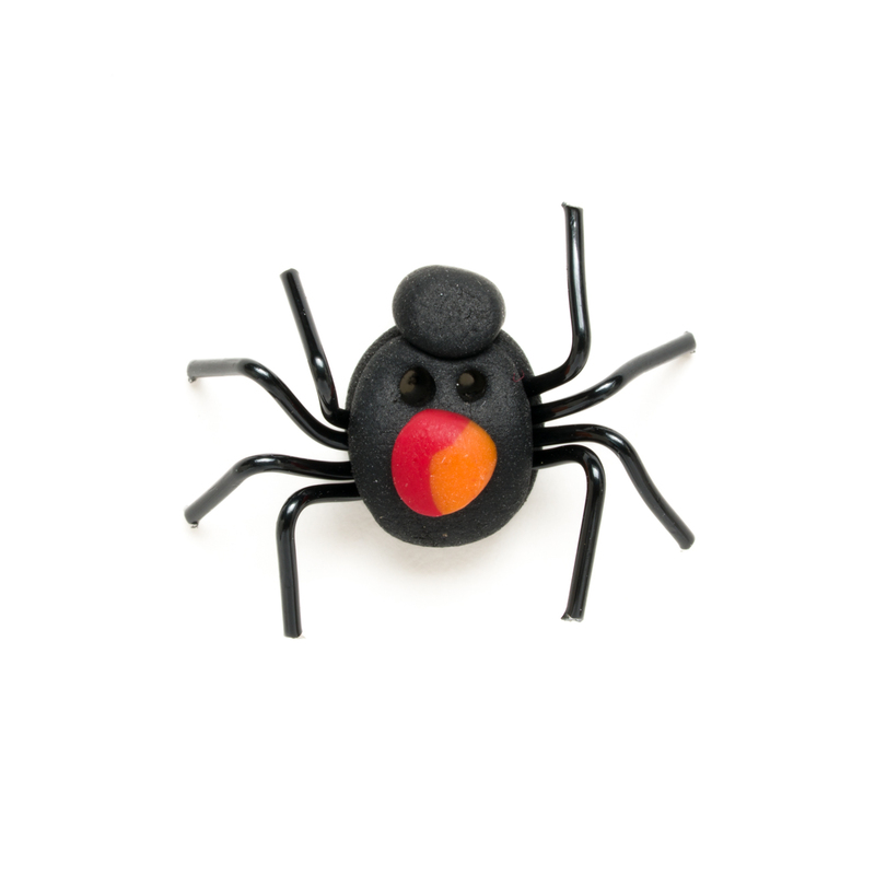Black, red, and orange spider clay button, isolated on a white background. 