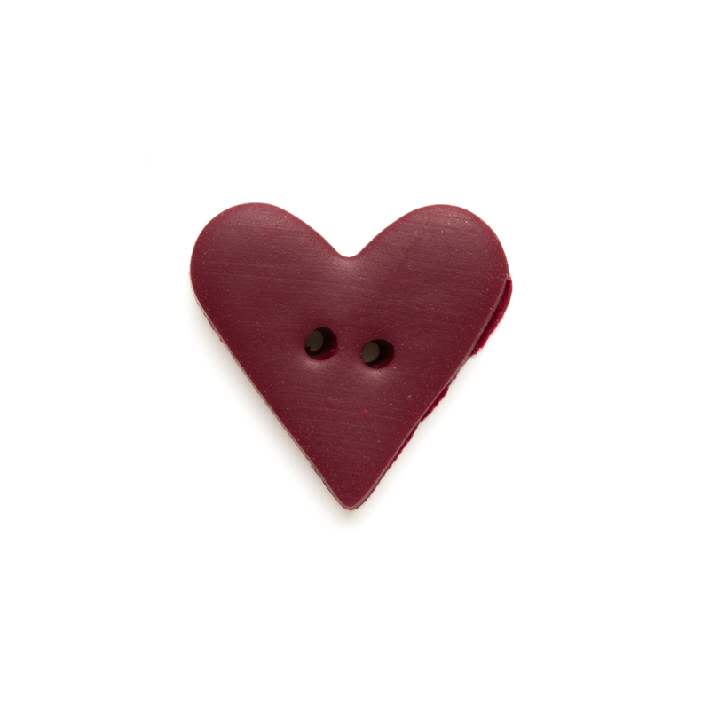 Maroon heart-shaped button on a white background.