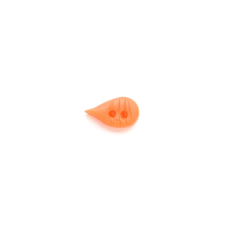 Orange carrot-shaped clay button on a white background.